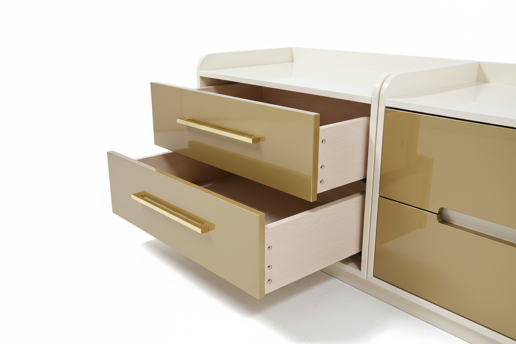 Close up of gold handles and open drawers on luxury bedside pedestal